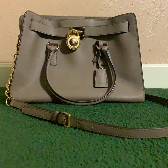 Michael Kors Handbags - I am selling a grey Michael Kors bag, + body strap